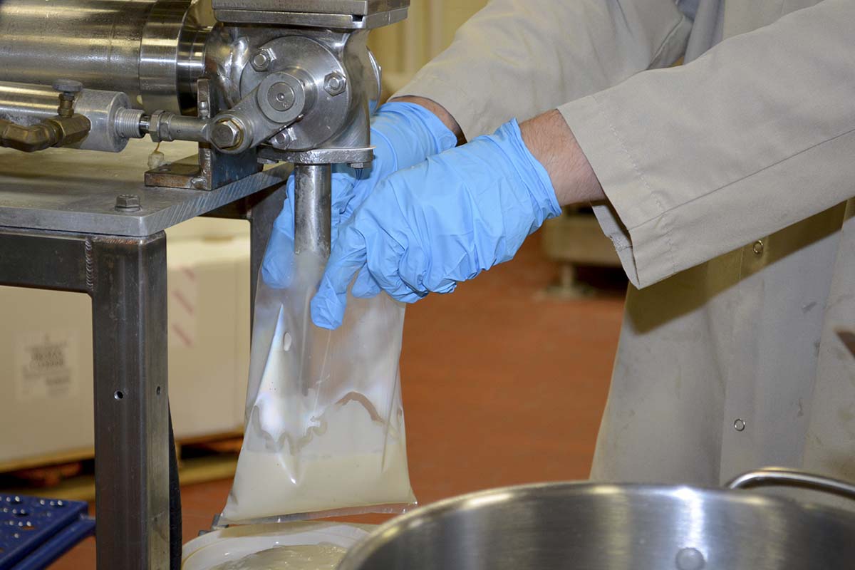 equipment filling a bag with alfredo sauce